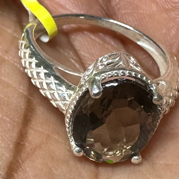 This is a sterling silver ring featuring a smoky quartz gemstone